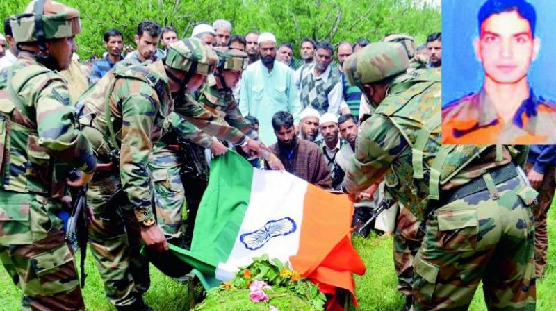 Army personnel pay tribute to the slain army officer Lt. Ummer Fayyaz during his funeral at his native village Sudsona in Kulgam district on Wednesday. (Photo: PTI)