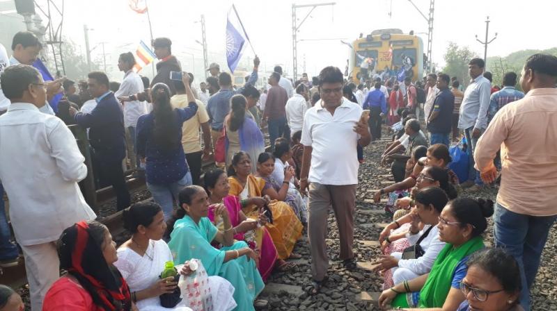 Protesters seen occupying the railway tracks at Nallasopara station, Mumbai. (Photo: ANI/Twitter)