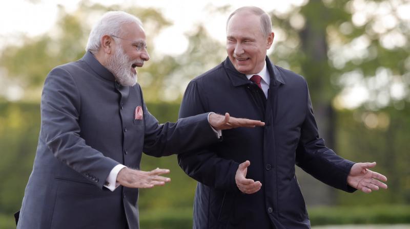 Prime Minister Narendra Modi and Russian President Vladimir Putin talk to each other as they walk at the St. Petersburg International Economic Forum in St. Petersburg, Russia. (Photo: AP)