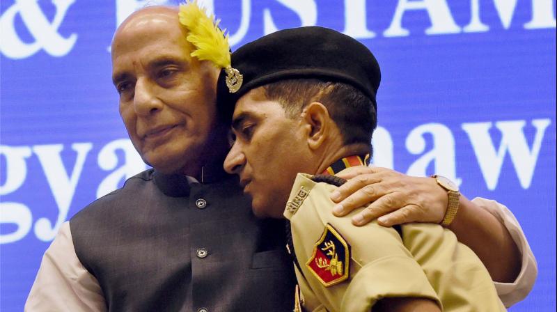 Union Home Minister Rajnath Singh after presenting Police Medal to constable Godhraj Meena, who took on militants when they attacked a BSF bus in Udhampur in J&K on August 5, 2015, at the 15th BSF investiture ceremony in New Delhi. (Photo: PTI)