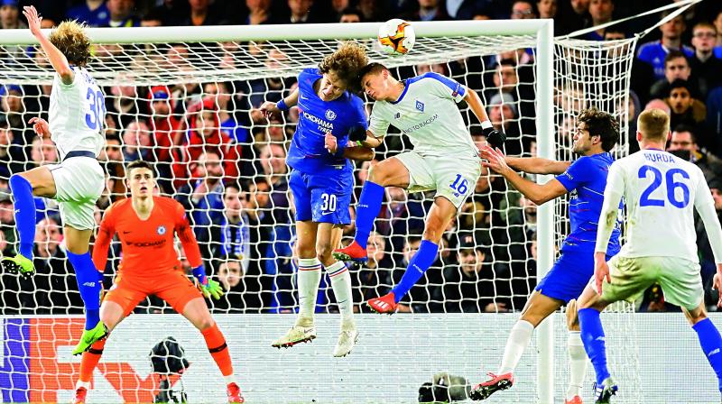 David Luiz (No.30) of Chelsea and Dynamo Kievs Vitaliy Mykolenko head the ball during their Europa League Round of 16 first leg match at Stamford Bridge stadium in London on Thursday. Chelsea won 3-0. (Photo: AP)