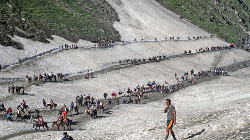 Pilgrims, on the Baltal route, cross mountain trails on their way to the Amarnath cave shrine on the Baltal route. (Photo: PTI)