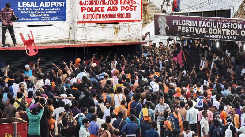 A video journalist who climbed up the  sun-shade of a building to capture the protest being attacked by the protesters in Sabarimala on Tuesday.