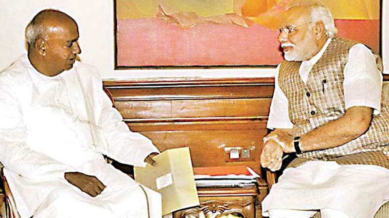 Former PM and JD(S) supremo H.D. Deve Gowda seen with Prime Minister Narendra Modi in this (File photo).