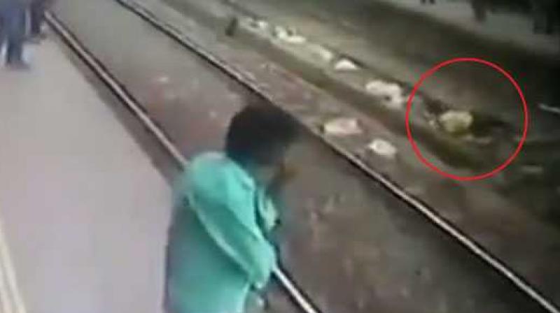 The man was rescued by the Railway Protection Force worker and passengers waiting at the platform. (Photo: Screengrab | ANI)