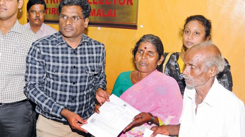 Kannan and Poongavanam get their property documents from Tirunavannamalai  collector K.S. Kandasamy. 	K. SENTHIL NATHAN