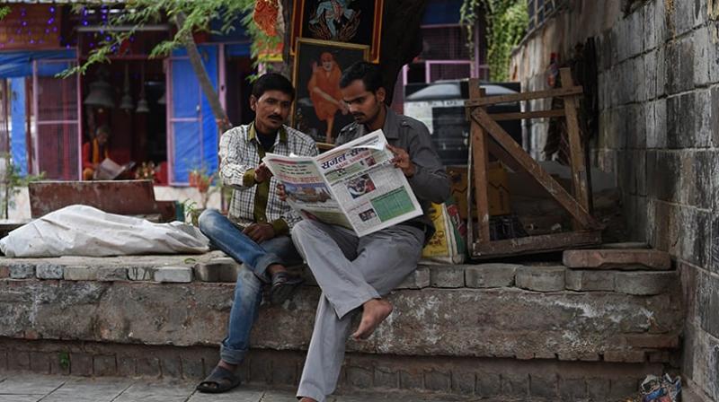 The report compared the time spent with newspapers in 2016 against the time spent at the turn of the millennium (Photo: AFP)