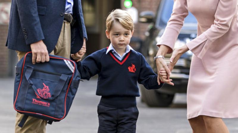 Britains Prince William accompanies Prince George as he is met by Helen Haslem - the head of the lower school on arrival for his first day of school at Thomass school in Battersea, London, Thursday, Sept. 7, 2017. (Photo: AP)