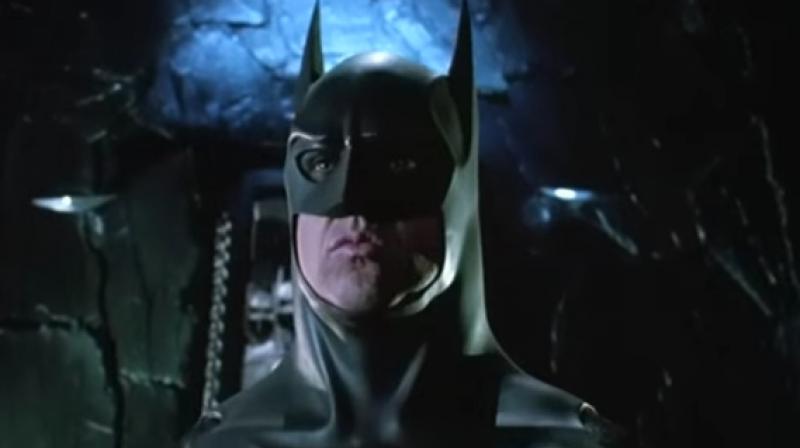 The costume is displayed on a mannequin with the chiseled likeness of Keaton and stands at approximately 6-foot-5 and is displayed on a 2-inch gray and white mounted base with Batman Returns titled on the front center. (Photo: Youtube)