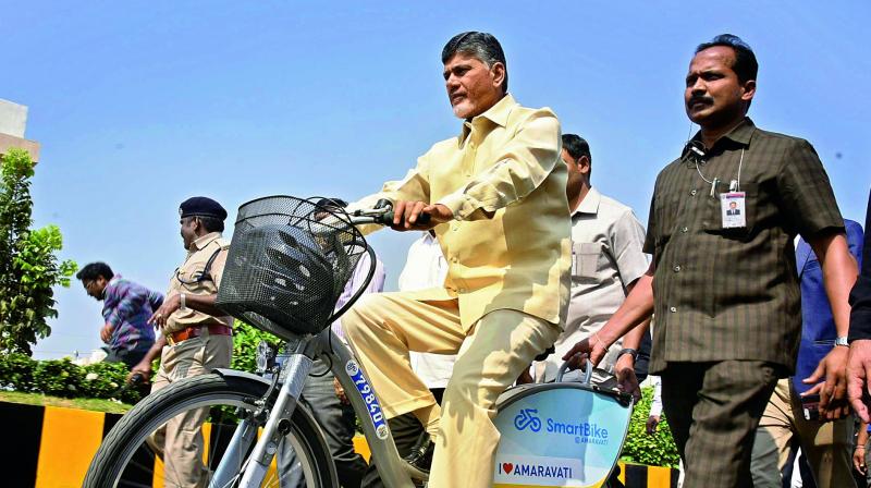 Chief Minister N. Chandrababu Naidu rides the smart bike after inauguration at Secretariat on Wednesday.(Photo: DC)