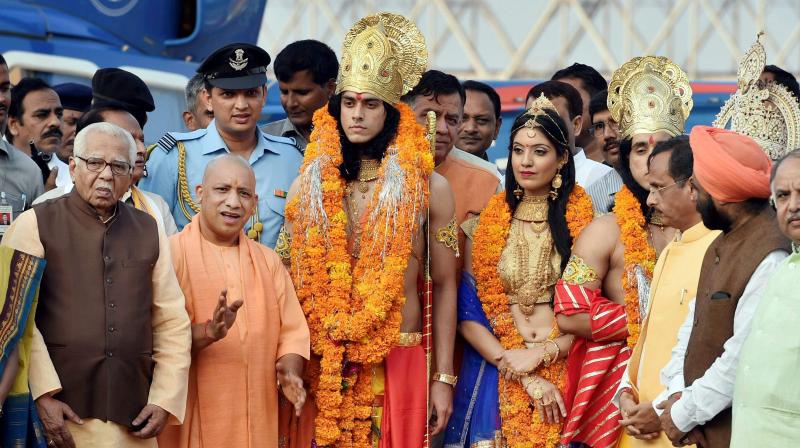 Uttar Pradesh Governor Ram Naik and Chief Minister Yogi Adityanath with artistes dressed up as Lord Rama Sita and Lakshman during Deepotsav celebrations in Ayodhya. (Photo: PTI)