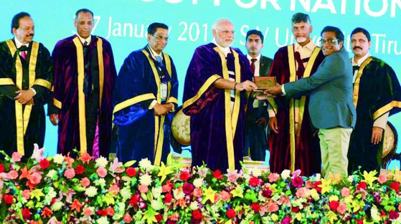 UoH Vice-Chancellor Prof. Appa Rao Podile receives the Millennium Plaque of Honour from Prime Minister Narendra Modi in Tirupati on Tuesday. 	(Photo: DC)