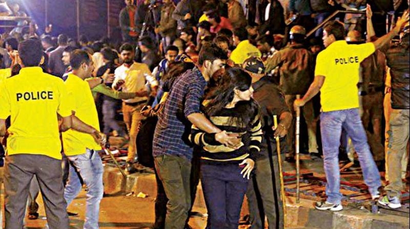 A woman protects herself against the mob on New Years Eve in  Bengaluru