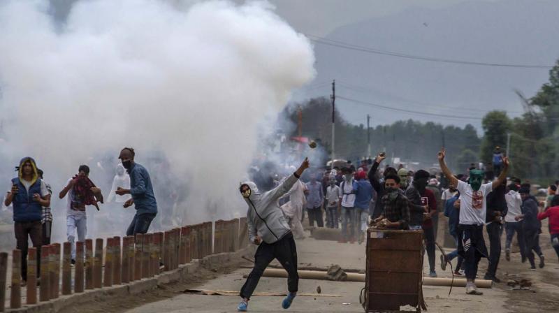 Kashmiri demonstrators throw stones at the police during a protest on the outskirts of Srinagar. (Photo: AP)