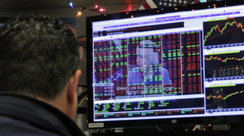 Federal Reserve Chair Janet Yellens news conference in Washington is reflected on a specialists screen on the floor of the New York Stock Exchange.  (Photo:AP)