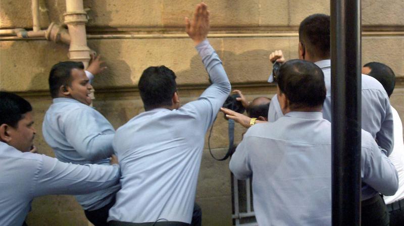 Private security personnel of Tata Group assault photojournalists who had assembled ahead at Bombay House for the Indian Hotels board meeting. (Photo: PTI)