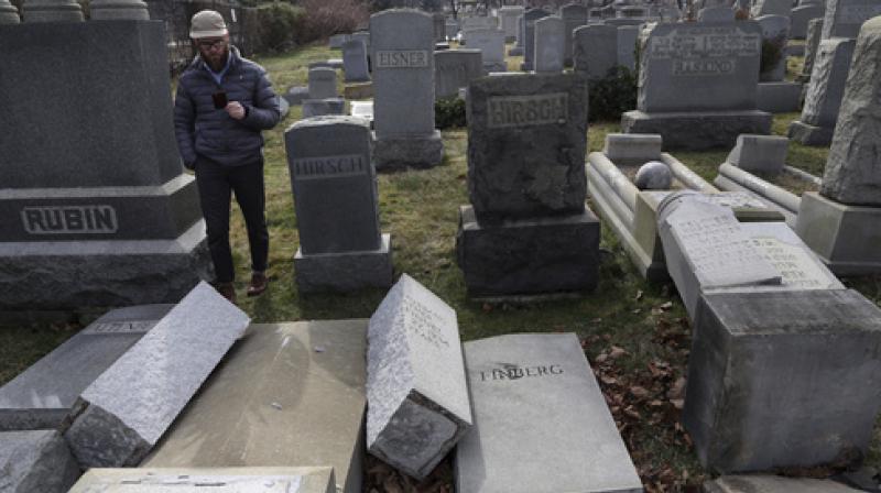 Rabbi Joshua Bolton of the University of Pennsylvanias Hillel center surveys damaged headstones at Mount Carmel cemetery. (Photo: AP)