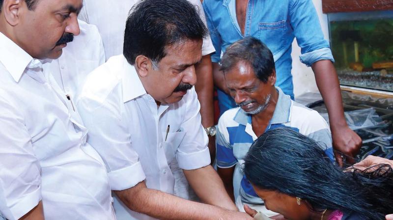 Opposition leader Ramesh Chennithala consoles Sreejiths parents at their residence in Varapuzha on Thursday. V.D. Satheesan, MLA, is also seen. (Photo: DC)