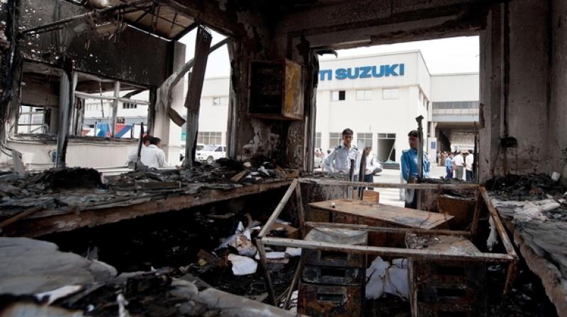 The violence on August 18, 2012 broke out over wage issues when a group of employees allegedly torched a section of MSIL facility. (Photo: AFP)