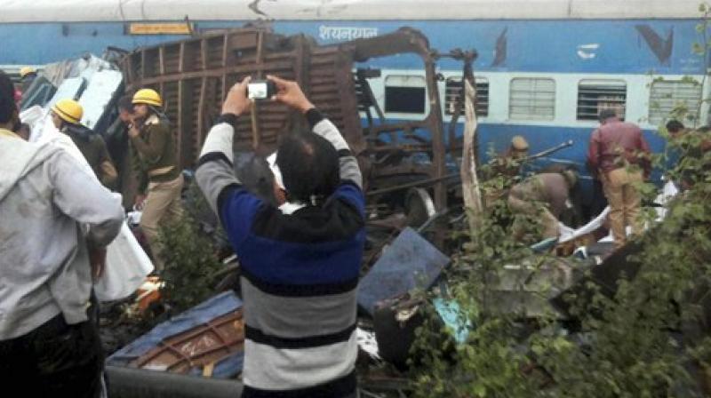 Rescue officials on the spot where 14 coaches of the Indore-Patna express derailed, killing around 90 people and injuring 150, in Kanpur Dehat on Sunday. (Photo: PTI)