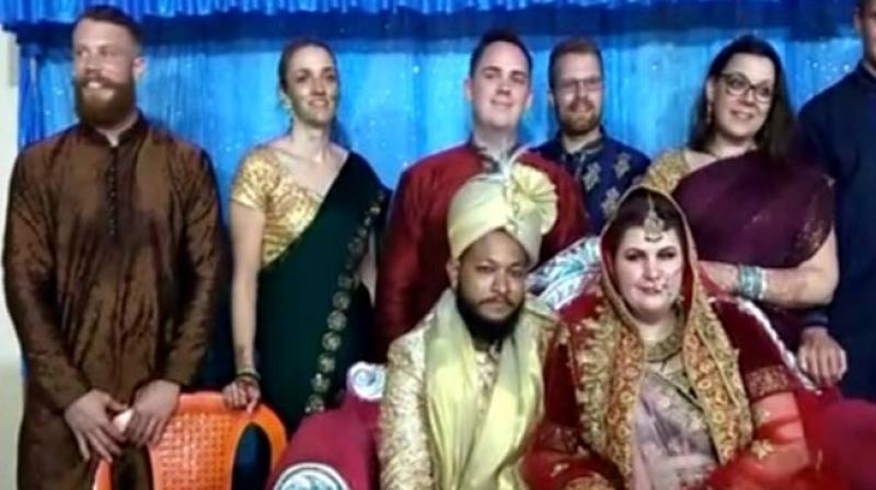 Emma Lorre, the girl from Sweden, and Mohammad Azharuddin of Kandhamal take a picture with family members after their wedding ceremony on Sunday.  DC