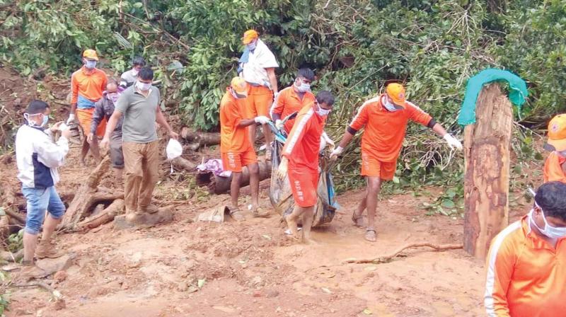 NDRF team recovers a body from the slush in flood-hit Kodagu on Saturday.