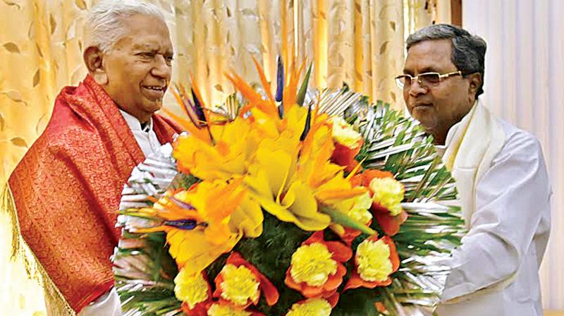 CM Siddaramaiah greets Governor Vajubhai Vala on his birthday at Raj Bhavan on Monday 	(Photo:  KPN)