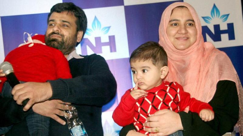 Zeenia (L), two and half year old girl from Sahiwal in Pakistan who underwent successful Bone Marrow Transplant at Narayana Health City hospital in Bengaluru on Friday. Donor of bone marrow is her 8 months old brother Ryan (R) said to be the youngest donor with her father Zia Ulla (L). (Photo: PTI)