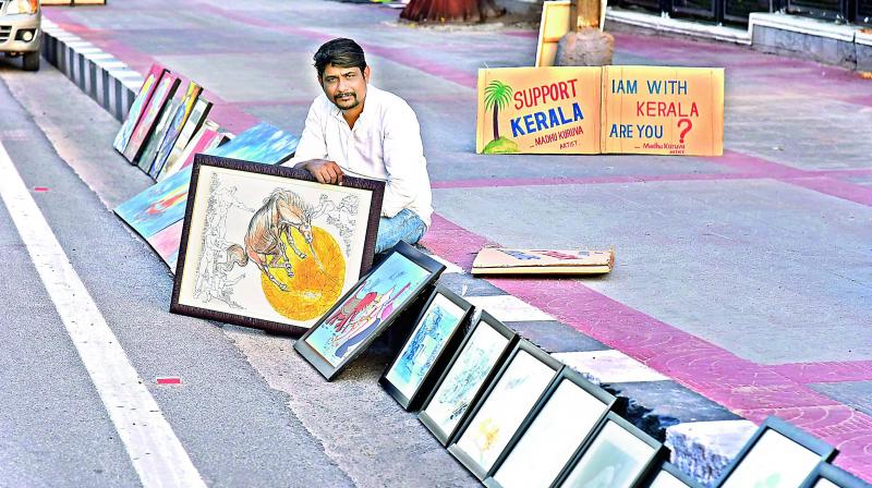 Madhu Karuva displaying his art work.