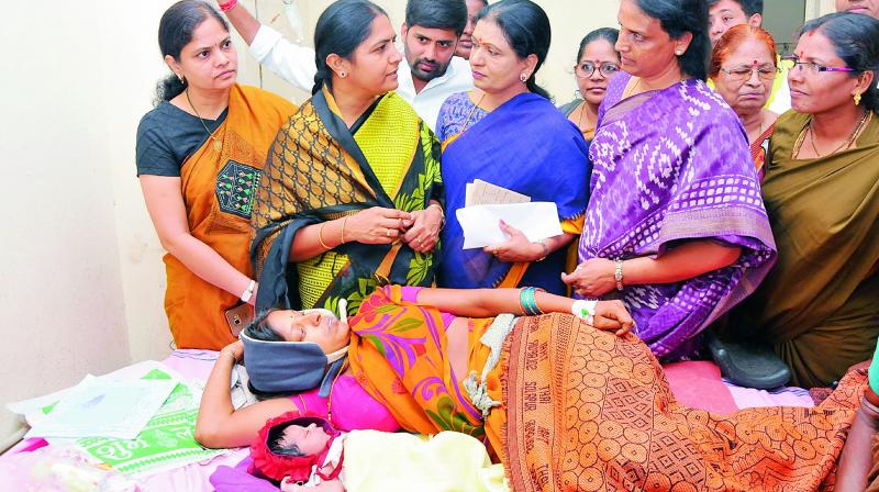 Congress leaders D.K. Aruna, Sabita Indra Reddy, Sunita Laxma Reddy, Banda Karthika Reddy and others crowd around a patient at the Koti maternity hospital on Monday, unmindful of the requirement to keep the maternity ward housing newborns clean. (Photo: P. Surendra)