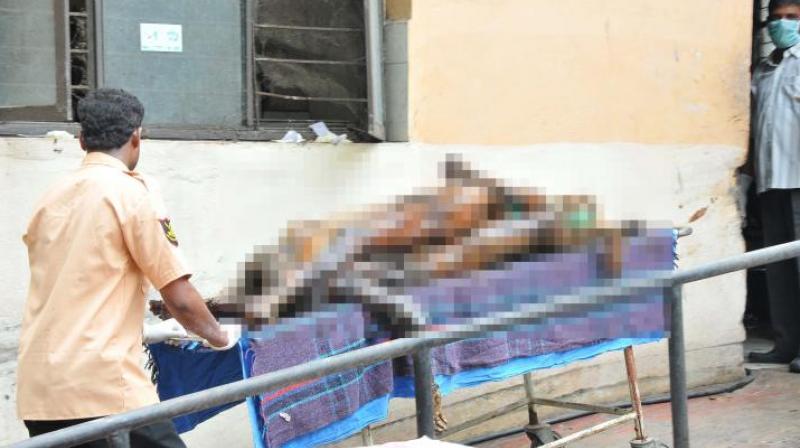 Bodies placed one on top of the other taken away by staffers, at the Osmania Hospital on Saturday. (Photo: DC)