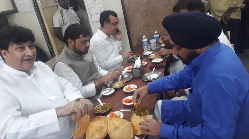 As the protest started, an image of Congress leaders including Ajay Maken, Haroun Yusuf and Arvinder Singh Lovely, gobbling down chhole bhaturas and other Delhi delicacies at a popular restaurant started doing the rounds. (Photo: ABI | Twitter)
