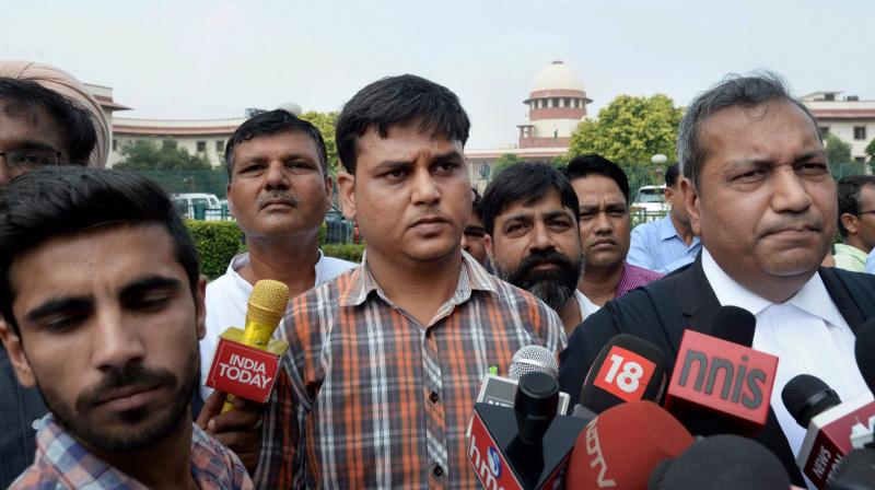 Varun Thakur, father of Pradyumna Thakur, the 7-year-old boy who was found murdered inside a Gurgaon school, talking to the media outside the Supreme Court in New Delhi on Monday. (Photo: PTI)