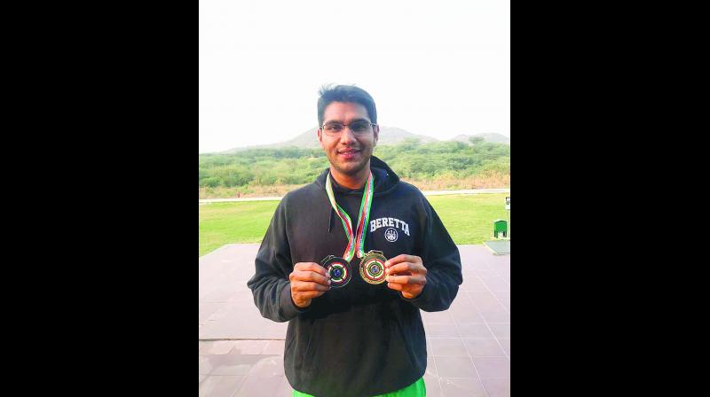 Kynan Chenai poses with his medals.