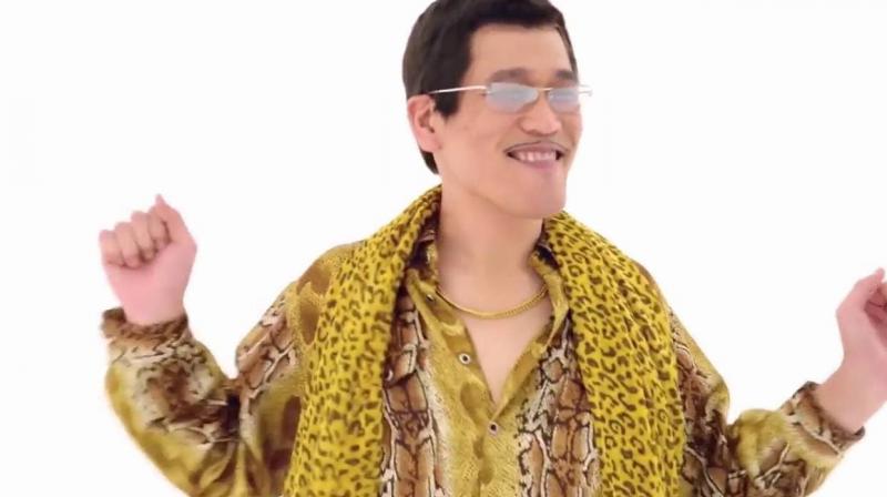 The video features Pikotaro, dressed in his trademark garish animal print costume, dancing to nonsensical English lyrics. (Credit: YouTube)