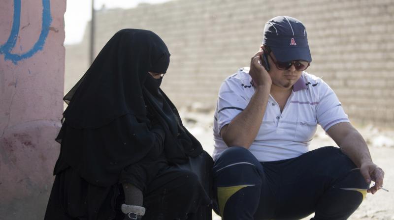 A man who identified himself as Omar Danoun talks on the phone in Gogjali, Iraq. (Photo: AP)