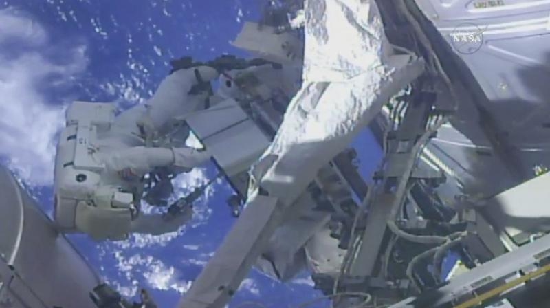 In this frame from NASA TV, NASA astronaut Ricky Arnold, left, and NASA astronaut Drew Feustel work on shuffling around a couple of space station pumps at the International Space Station on Wednesday, May 16, 2018. (NASA TV via AP)