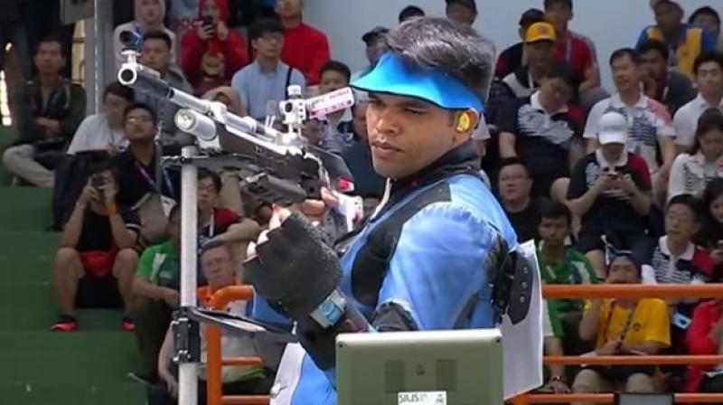 Indian shooter Deepak Kumar claimed the silver medal in mens 10m air rifle event after producing excellent scores at crucial junctures, pipping fancied teammate Ravi Kumar at the 18th Asian Games. (Photo: Twitter / IOA India)