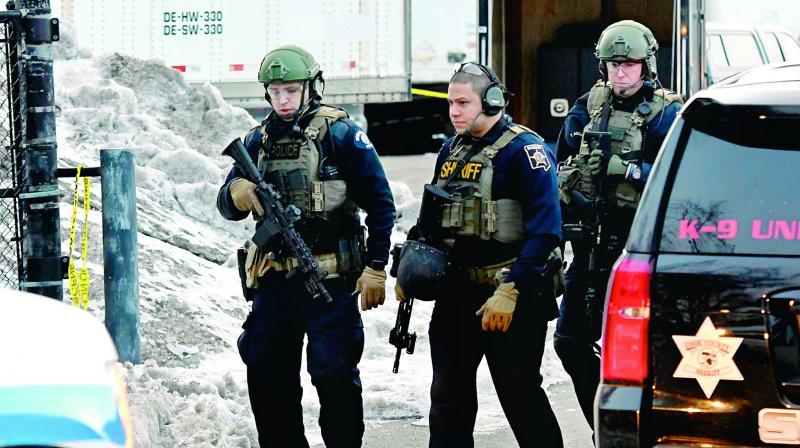 Law enforcement officers work at the scene of a shooting at the Henry Pratt Co. on Friday in Aurora, Ill. (photo:AP)