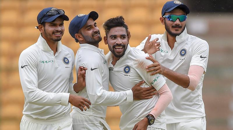 The trio of Siraj (10/128), Gurbani (4/92) and Navdeep Saini (3/71) took 17 out of the 20 wickets on a flat Chinnaswamy track. (Photo: PTI)