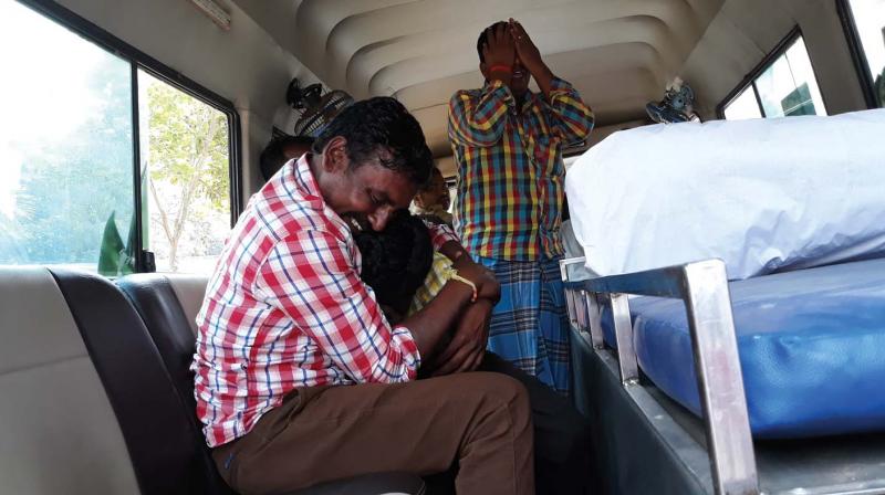 Relatives of Salamma, a victim, grieving in an ambulance near MMCRI mortuary on Sunday