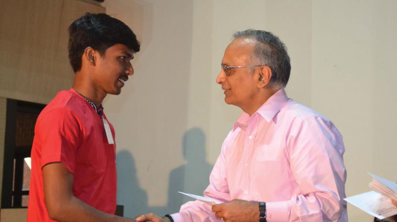 FFE founder Prabhu Goel awarding a scholarship cheque to an FFE scholar