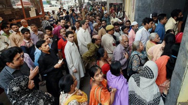 People queue outside a bank to exchange their old Rs 500 and 1000 notes. (Photo: PTI)