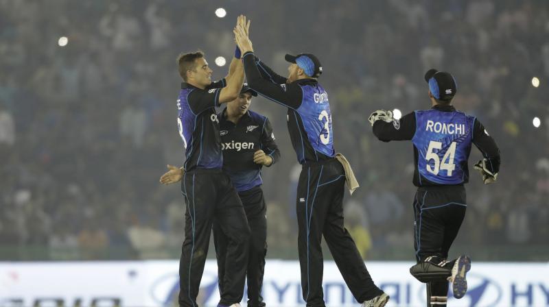 While Martin Guptill (second from right) shone with the bat, Tim Southee (far left) got the crucial wickets for New Zealand. (Photo: AP)