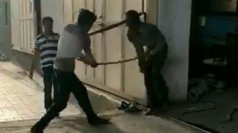 A video of the incident shows the Dalit man being tied up and beaten mercilessly with a stick by two men while he keeps crying out in pain. (Photo: Twitterscreengrab/@jigneshmevani80)