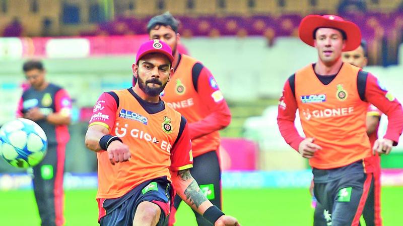 Virat Kohli and AB de Villiers during a training session of the Royal Challengers Bangalore team on Thursday.