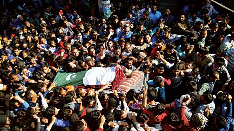 the dead tell a tragic tale: People carrying the body of one of the slain militants wrapped in a Pakistan flag in Shopian on April 1	. (Photo: H.U. Naqash)