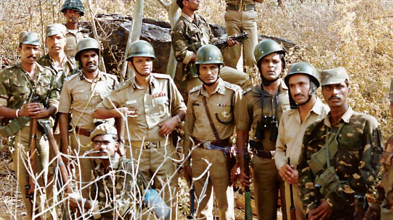 Forest and police officials after the seizure of 65 metric tonnes of sandalwood at Silvekal in Kollegal Division on February 22, 1990.