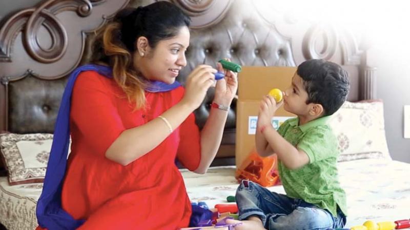 A mother and her son play with toys in this file photograph used for representational purposes only