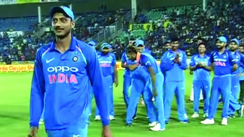 A screengrab of Hardik Pandya (behind) imitating Axar Patels walk as the left-arm spinner walks ahead to collect his award